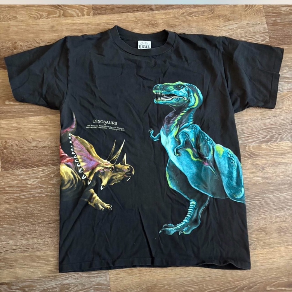 The Vintage T-shirt from 1993 features a wrap-around graphic of dinosaurs